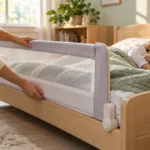 Toddler sleeping safely in a low bed with a properly fitted mesh bed rail